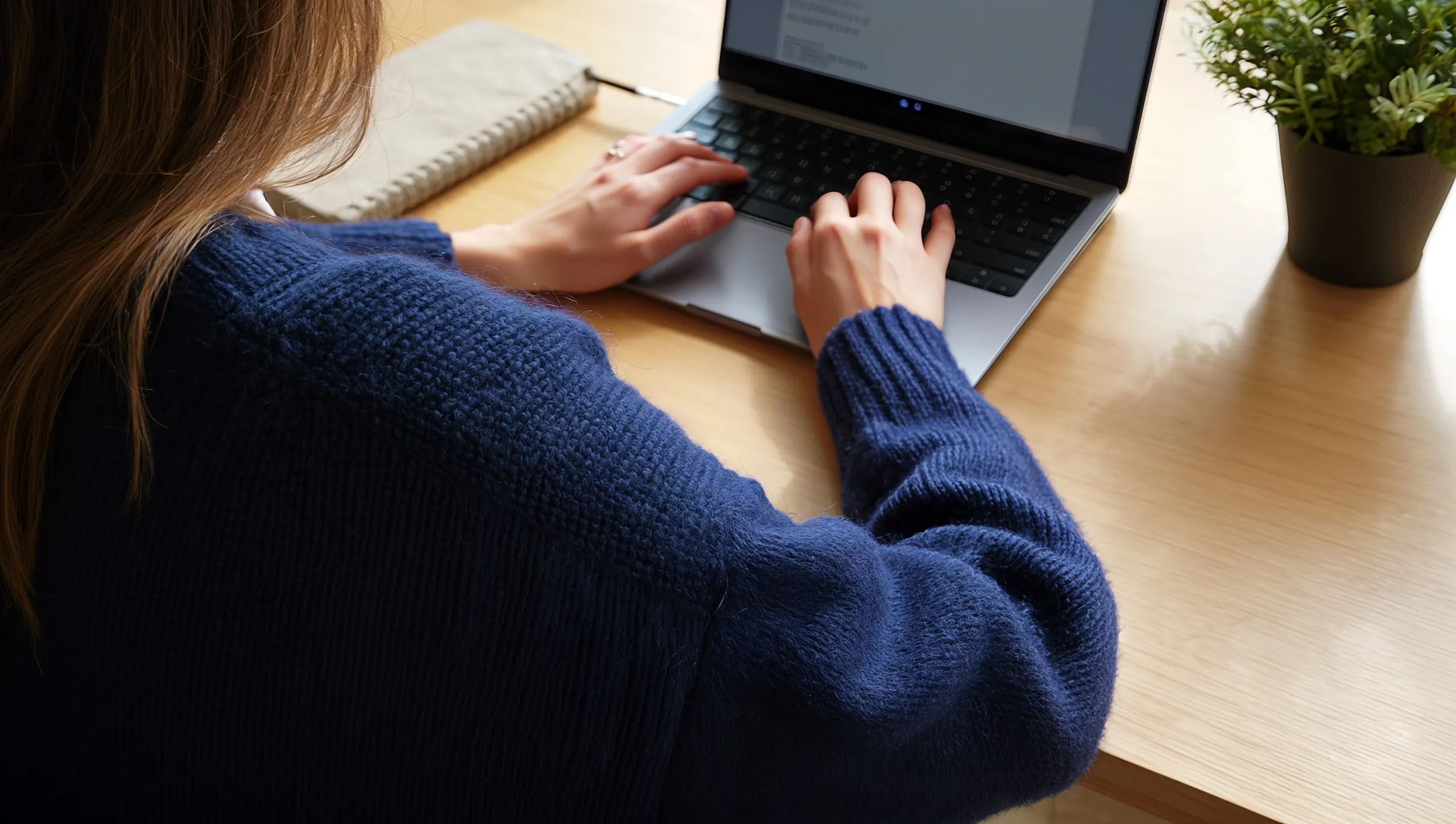 Person planning social media content on a laptop